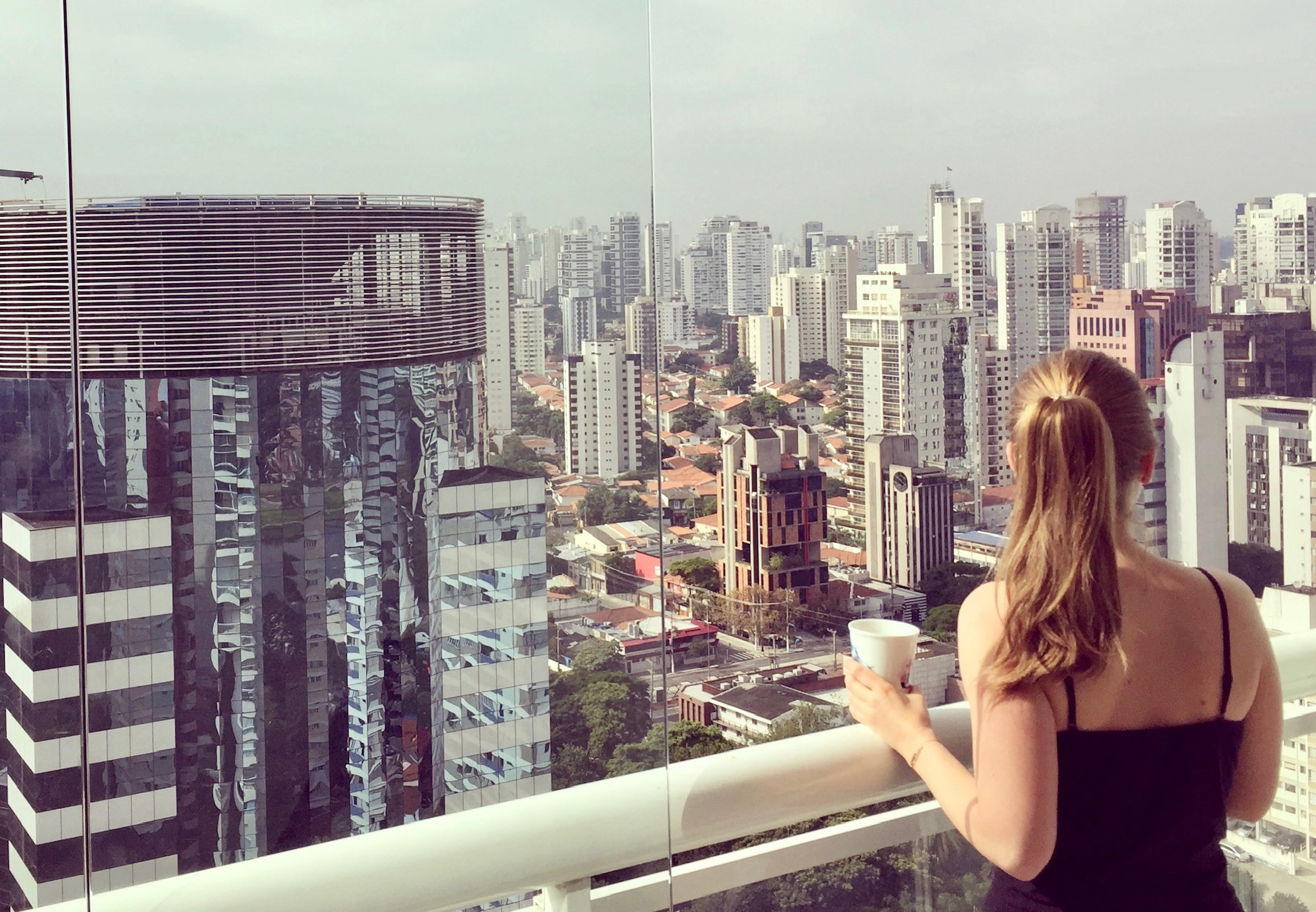 a female person with her back to the viewer looking at a skyline