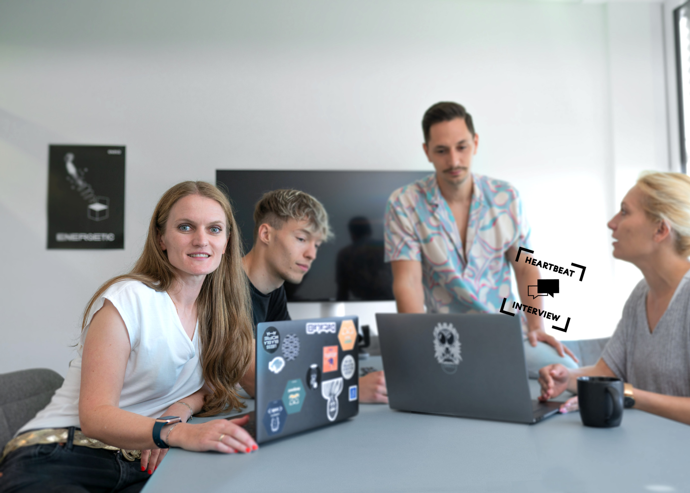 Gabriela Zitsch and team working with laptops at the desk