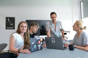 Gabriela Zitsch and team working with laptops at the desk